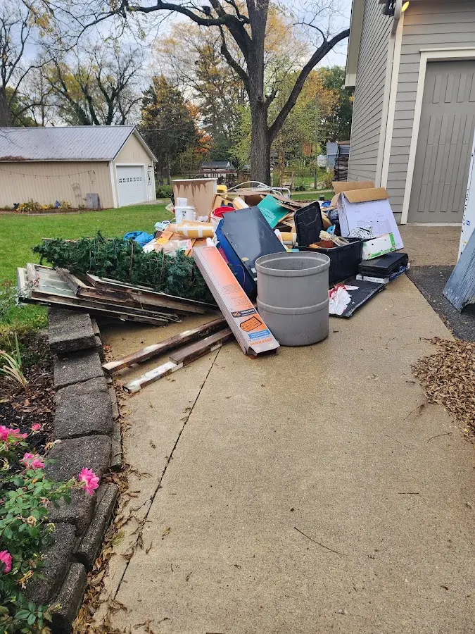 Dumpster being loaded with debris for Roofing Dumpster Rental in Bella Vista
